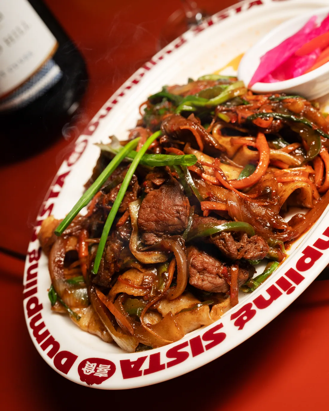 Wok-tossed wide noodles served on a Sista plate